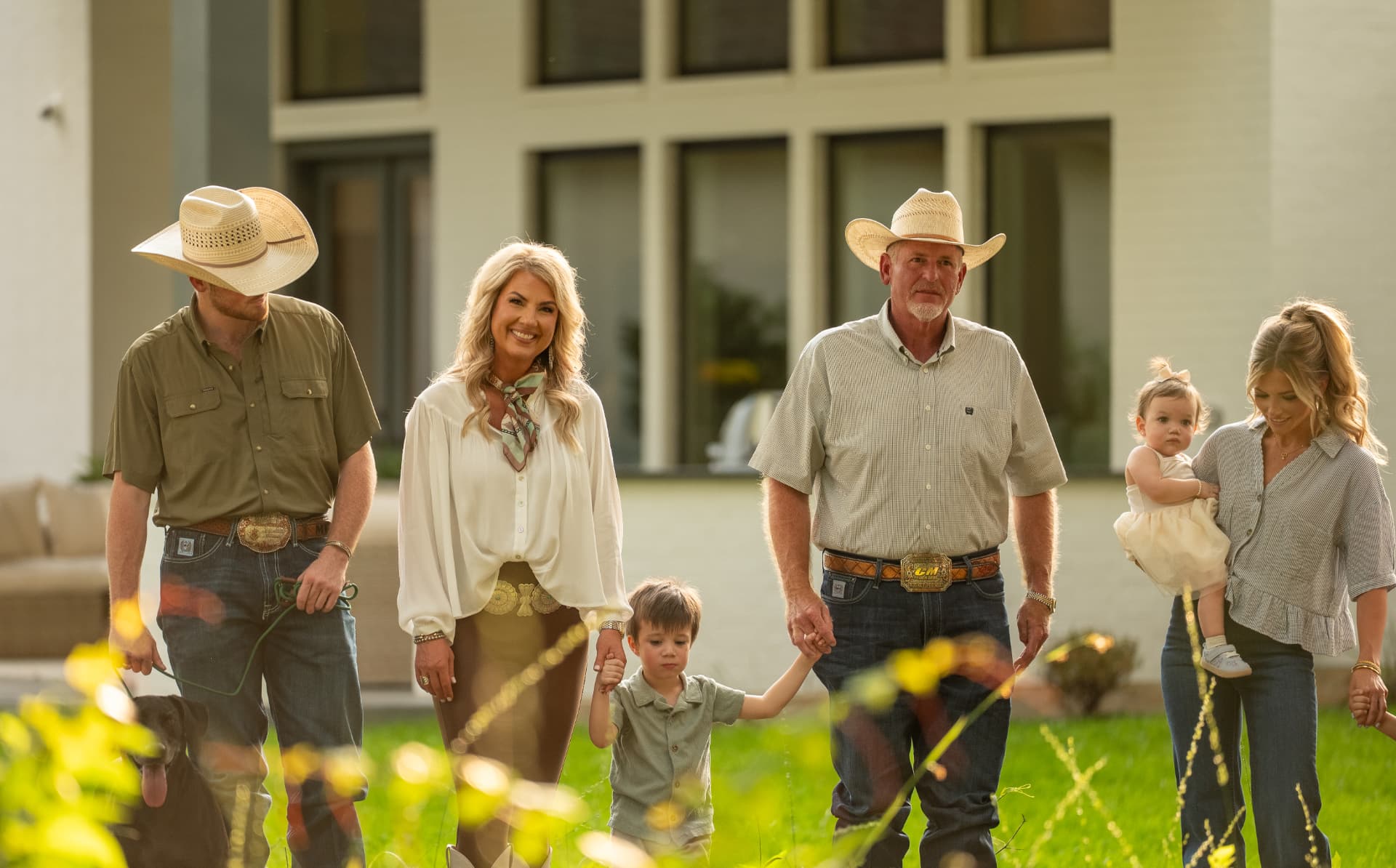 Lifestyle shoot photo of a ranch family walking together at their new homesite, directed and produced by Toni Bubb for Patten Properties